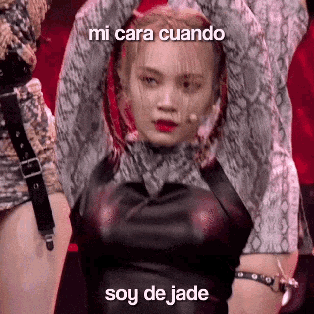 a woman in a snake print top is dancing with the words mi cara cuando soy de jade below her