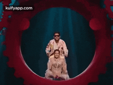 a man is riding a woman on his back through a red circle .