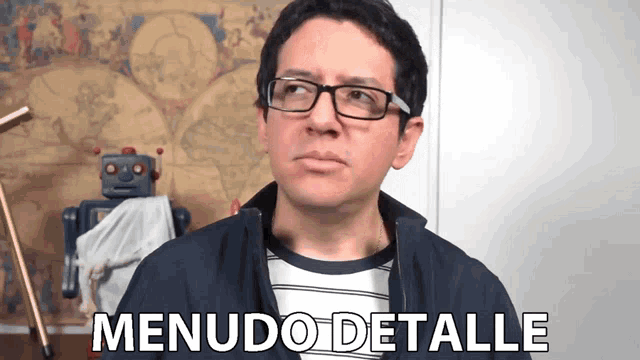 a man wearing glasses and a jacket says menudo detalle in front of a robot