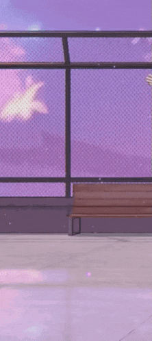 a man in a white shirt and blue pants is dancing in front of a fence and a bench