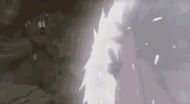 a person is standing in a dark room with a light coming out of their hand .