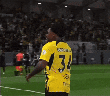 a soccer player wearing a yellow shirt with the number 34 on it