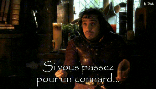 a man sitting at a table with the words " si vous passez pour un connard " written on the bottom