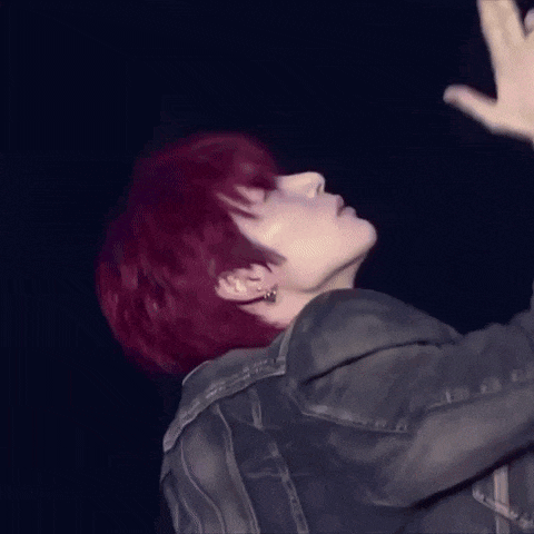 a man with red hair is wearing a denim jacket