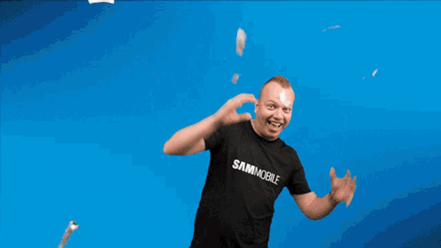 a man wearing a shirt that says sammobile is surrounded by confetti
