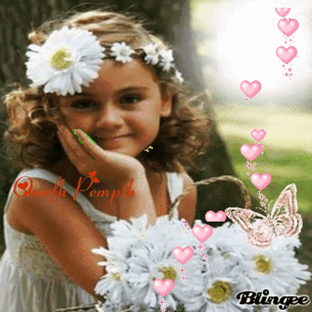 a little girl with a flower in her hair is holding a bouquet of flowers