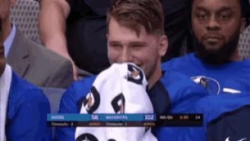 a man covering his mouth with a gatorade towel