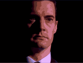 a man in a suit and tie is making a funny face