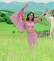 a woman in a pink dress is standing in a field of tall grass
