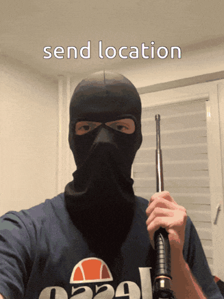 a man wearing a ski mask is holding a stick with the words send location written above him