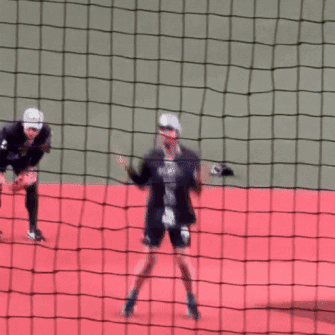 a blurred image of a person jumping over a fence with a jersey that says ' a ' on it