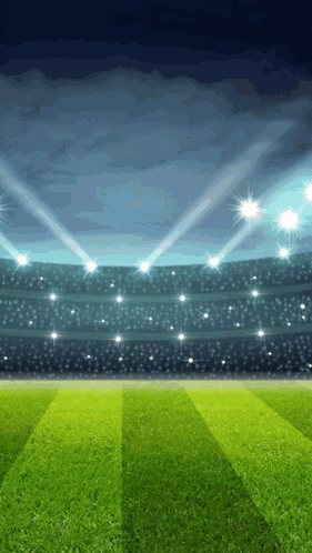 a soccer field with a stadium in the background and spotlights shining on it