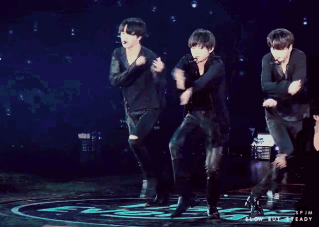 two men are dancing on a stage and the words slow but steady are on the bottom right