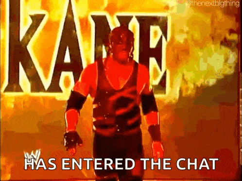 a wrestler is standing in front of a fire and says " kane has entered the chat "