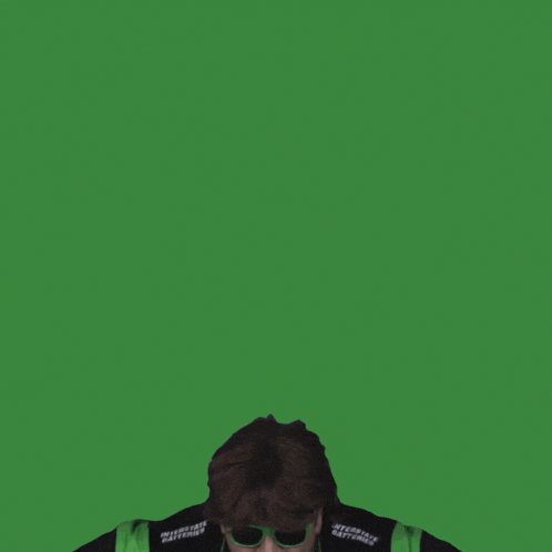 a man wearing sunglasses and a jacket that says " interstate batteries "