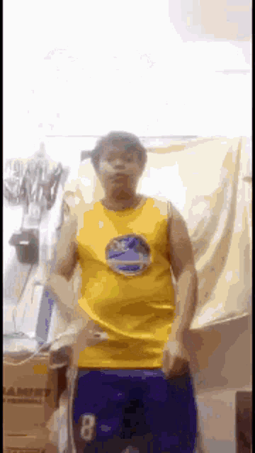 a man in a golden state warriors jersey is dancing