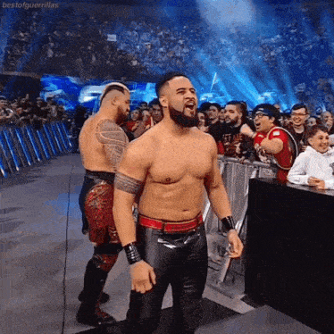 two wrestlers are standing in front of a crowd with the hashtag bestofguerrillas at the bottom