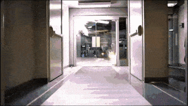 a hallway with a sliding glass door and a sign that says exit