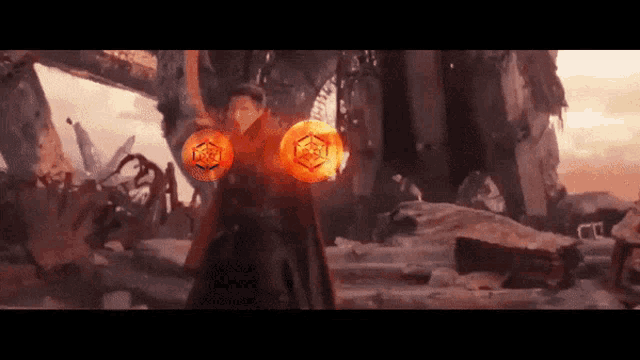 doctor strange is holding a pair of glowing spheres