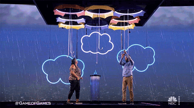 a man and a woman are standing in front of umbrellas hanging from the ceiling