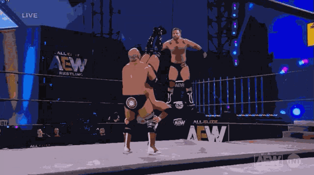 a wrestler in a ring with the word aew behind him