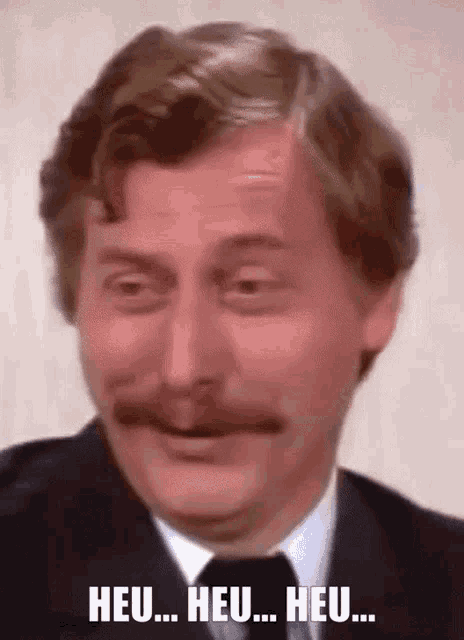 a man with a mustache is making a funny face and says heu heu heu
