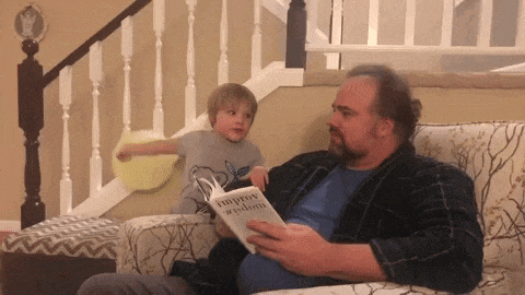 a man is reading a book called improv wisdom