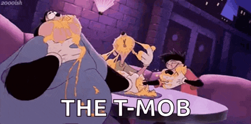 a cartoon character is sitting at a table with a plate of food and the words `` the t-mob '' .