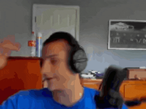 a blurry picture of a man wearing headphones in a room