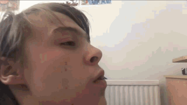 a close up of a person 's face with a radiator behind them