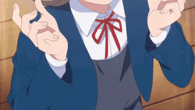 a girl with a blue jacket and a red bow tie is making a funny face