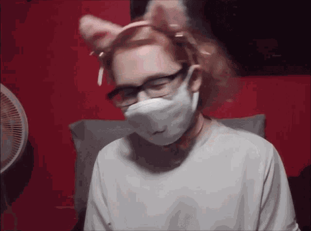 a person wearing a mask and a headband with ears