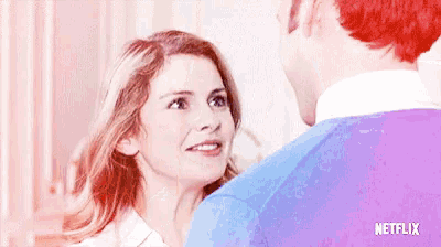 a man and a woman looking at each other with a netflix logo on the bottom