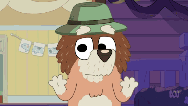 a cartoon dog wearing a green hat is standing in front of a baby shower banner