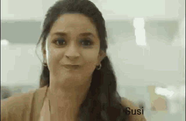 a woman is making a funny face and making a funny face .