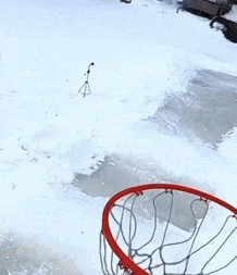 a person is jumping into a basketball hoop while holding a frisbee