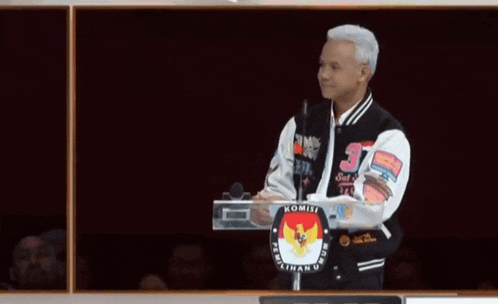 a man wearing a jacket that says ' komisi ' on it
