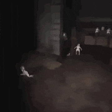 a couple of people are walking down a dark street at night .