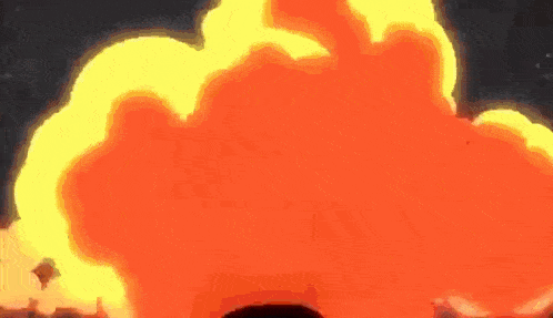 a person is standing in front of a large fireball in the sky .