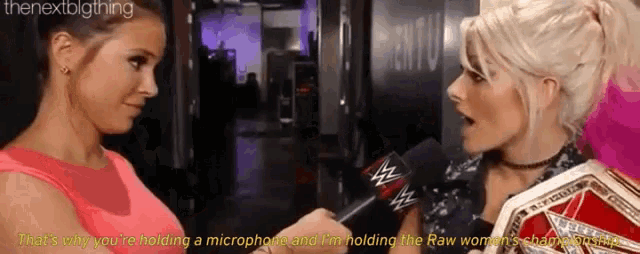 two women are talking to each other in front of microphones .