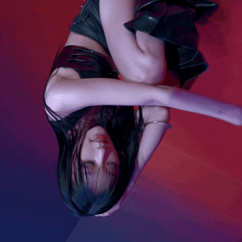 a woman in a black dress is upside down