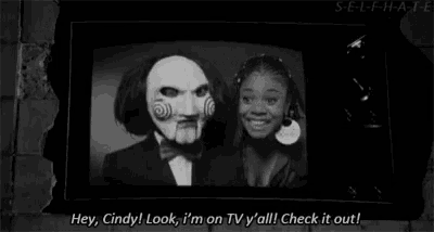 a black and white photo of a man in a mask standing next to a woman