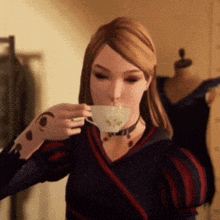 a woman is drinking a cup of tea from a white cup .