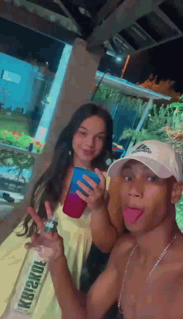 a man and a woman are posing for a picture together .