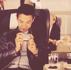 a man sitting at a table with a glass of water