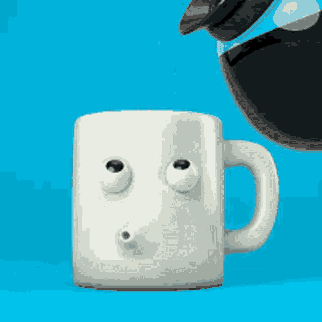 a white coffee mug with a face on it