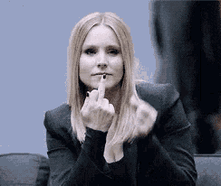 a woman in a black jacket is giving the middle finger .