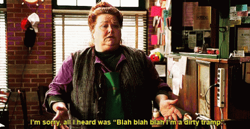 a woman in a purple vest says i 'm sorry