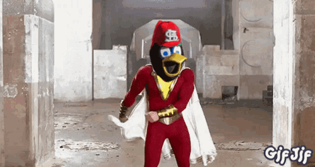 a gif of an angry bird in a superhero costume dancing