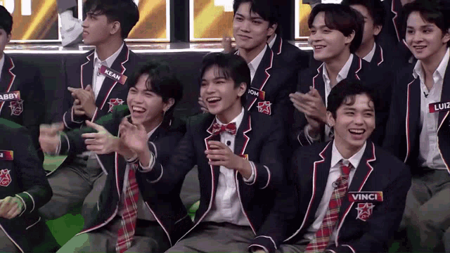 a group of young men wearing suits and ties including vince